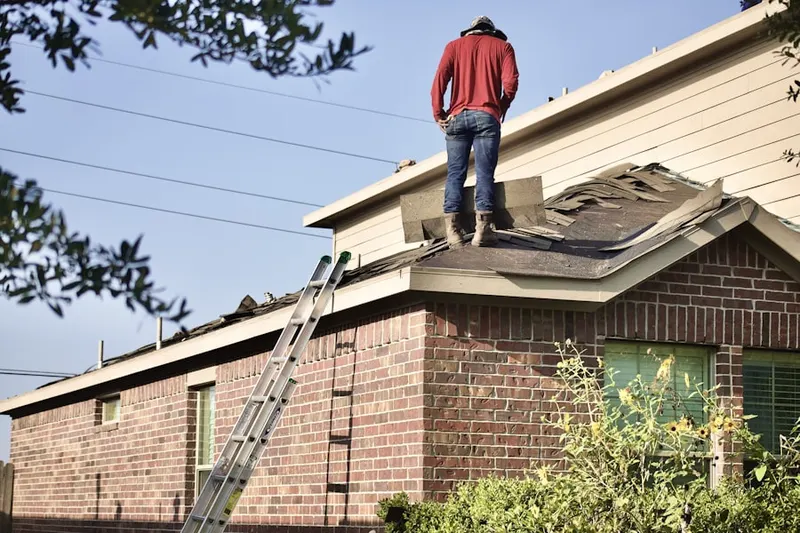 Professional roofer working on a residential roof in Pumptown